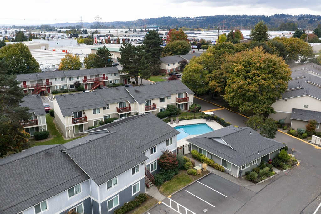 A large apartment complex with a pool in the middle.