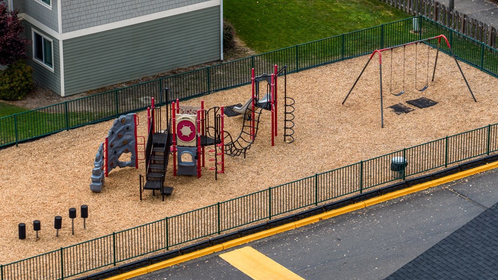 A playground with a slide, swings, and a sandbox.