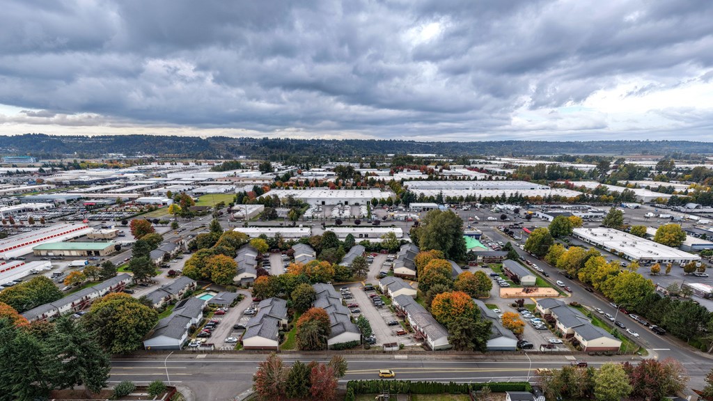 A cloudy day in a suburban area with a mix of residential and commercial buildings.