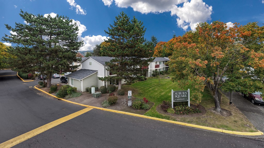 A sign that says "Aurora Quarry" is in front of some trees.