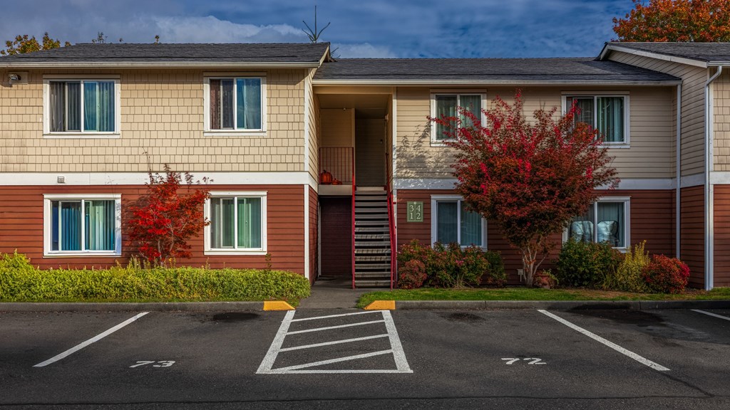 A building with a red tree in front of it.