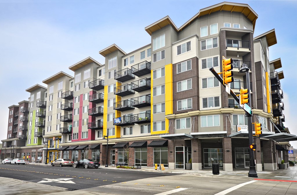A multi-story building with a yellow and brown exterior.