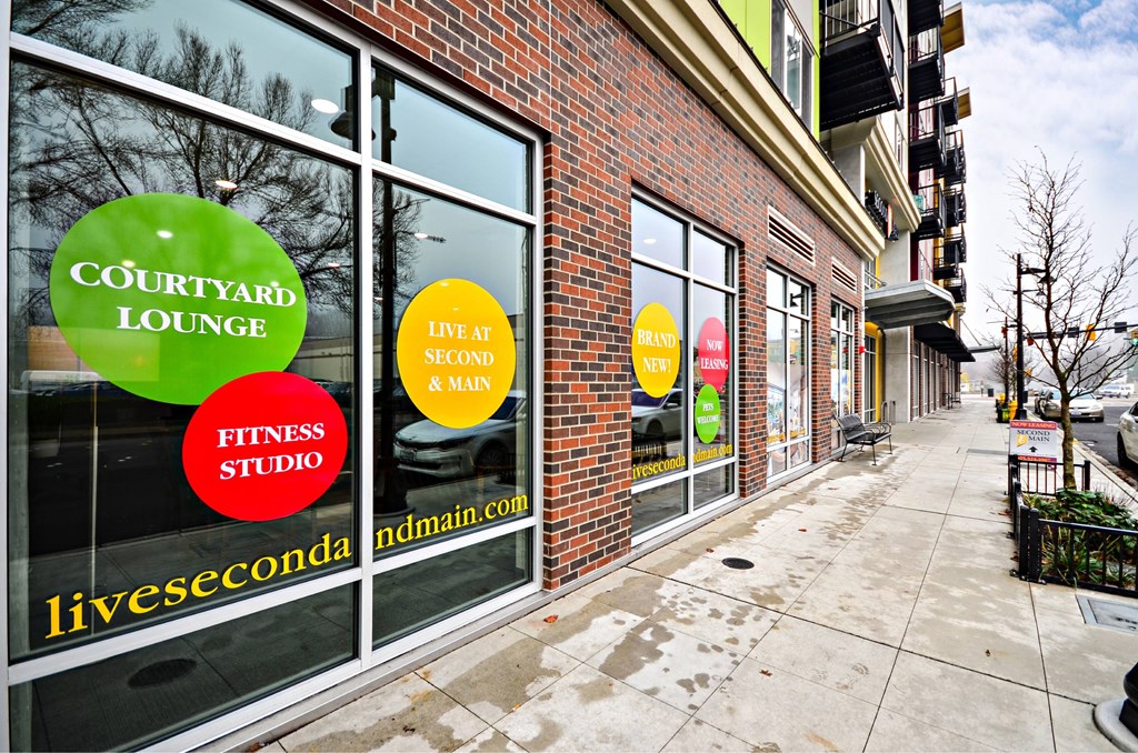 A storefront with a green sign that says Courtyard Lounge.