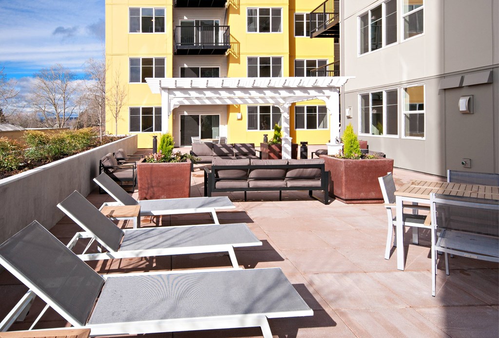 A sunny day at the patio with a yellow building in the background.