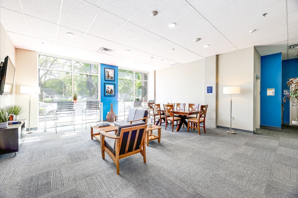 A conference room with a long table and chairs.