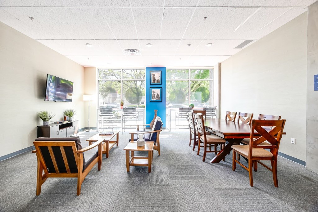 A conference room with a long table and chairs.