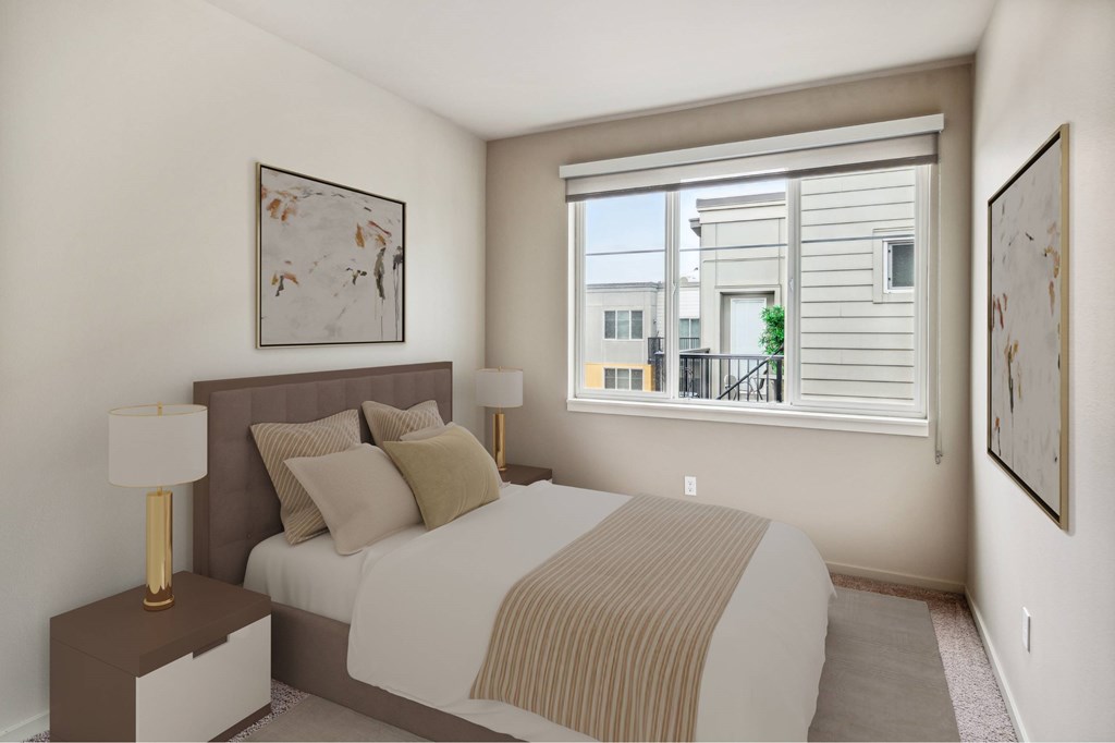 A bedroom with a large bed and a window overlooking a balcony.