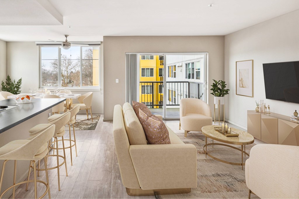 A modern living room with a bar area and a view of a yellow building outside.