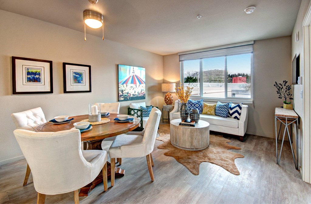 A dining room with a white table and chairs.