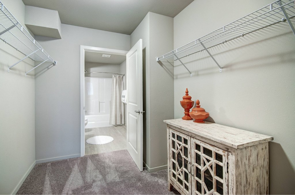 A hallway with a wooden cabinet and a carved object on top of it.