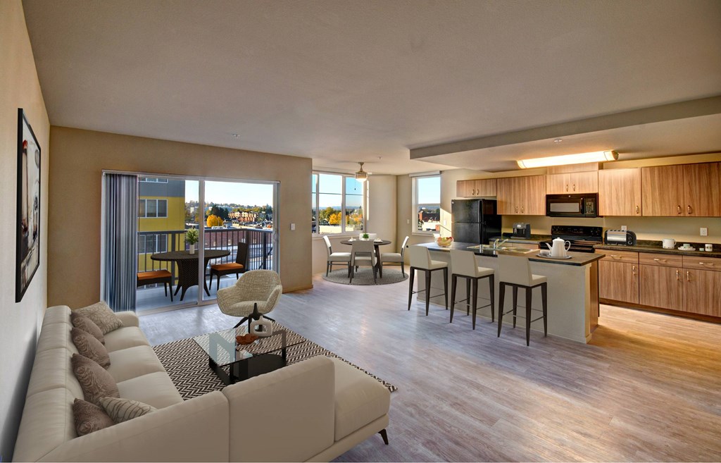 A modern living room with a large couch and a kitchen area in the background.