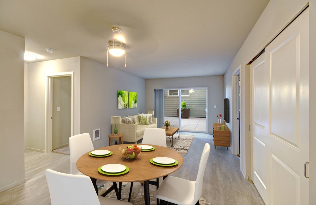 A dining room with a table set for four.