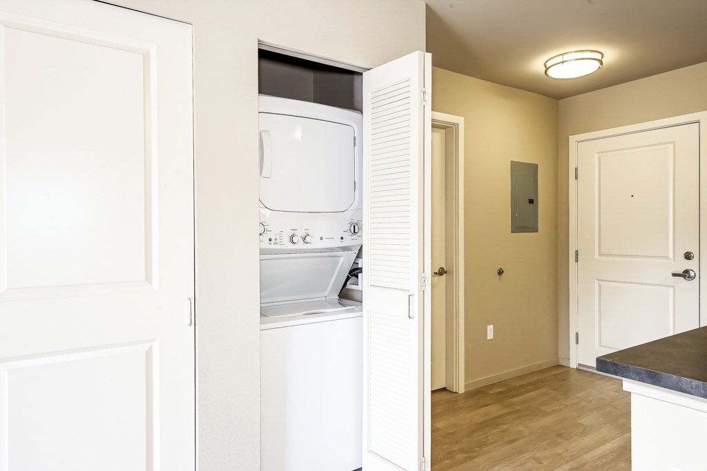 A white oven and microwave are installed in a kitchen.