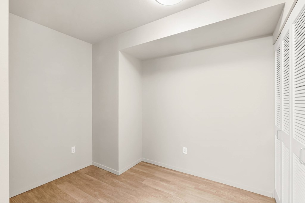 A room with white walls and wooden flooring.