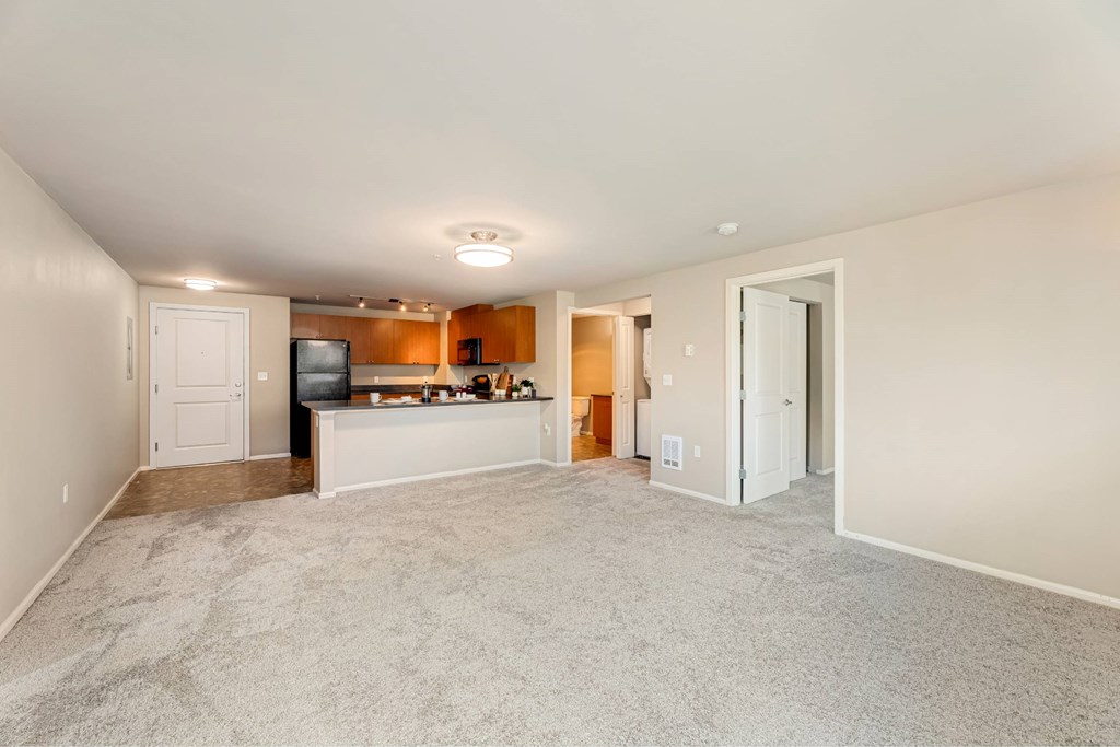 A living room with a television and a bar area.
