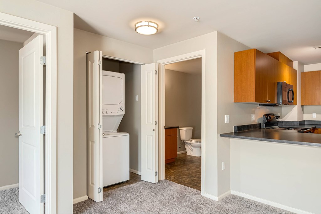 A kitchen area with a refrigerator, microwave, and toaster visible.