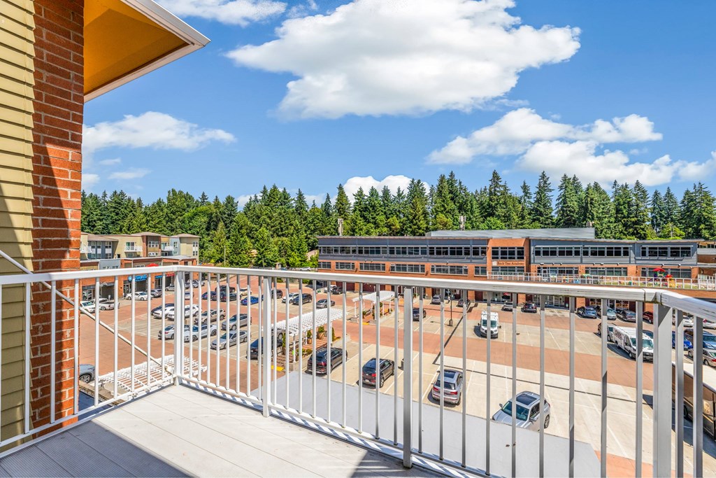 A parking lot with cars and a building in the background.