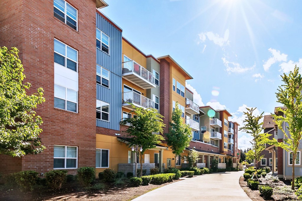 A sunny day at a residential building with a clear blue sky.