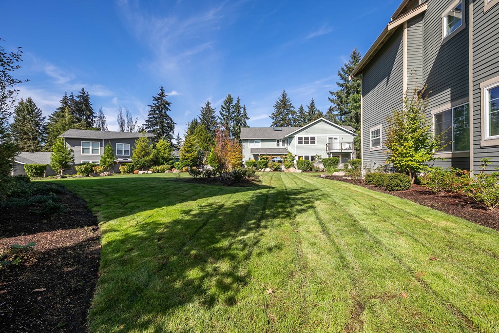 A residential area with houses and green lawns.