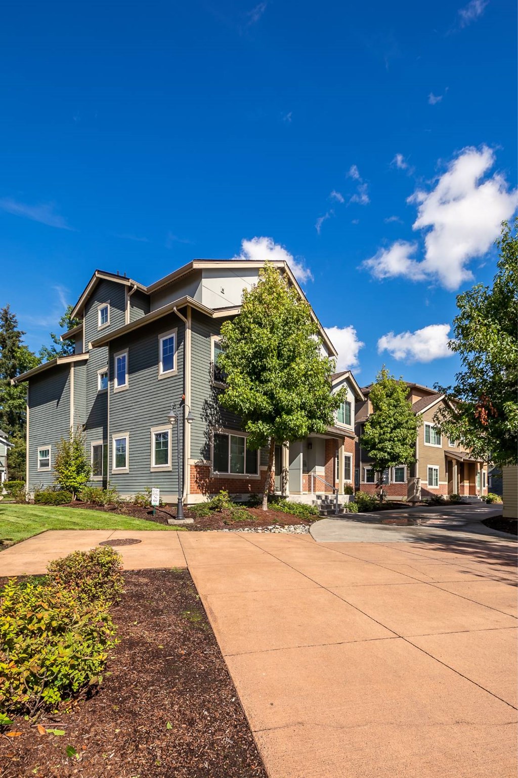 A large house with a driveway in front.