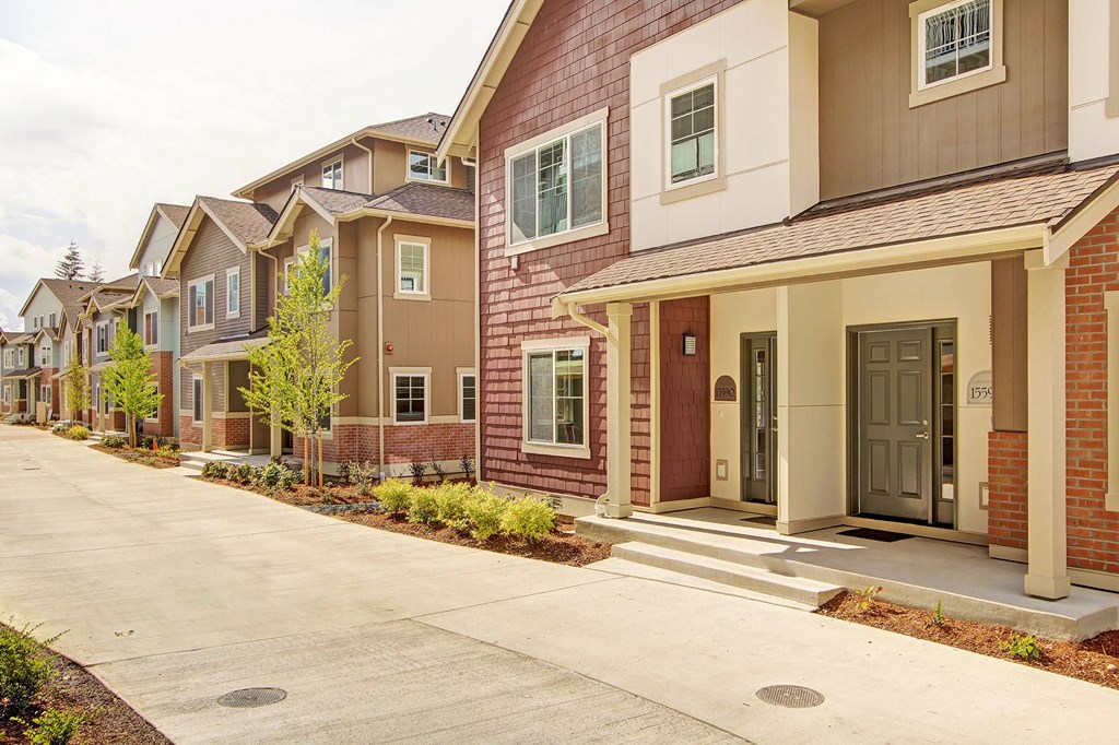 A row of houses with brown and beige exteriors.