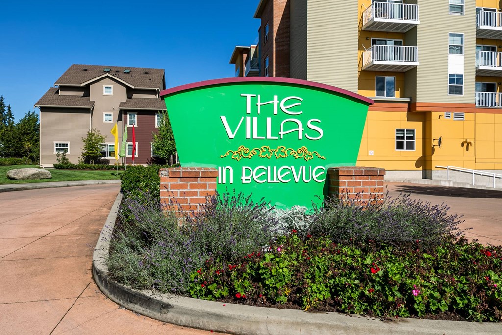 The Villas in Believe sign in front of a building.