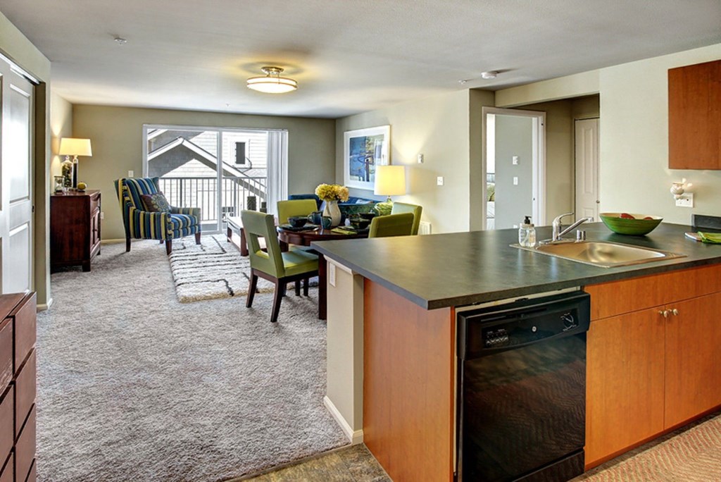 A kitchen with a black dishwasher and a sink.