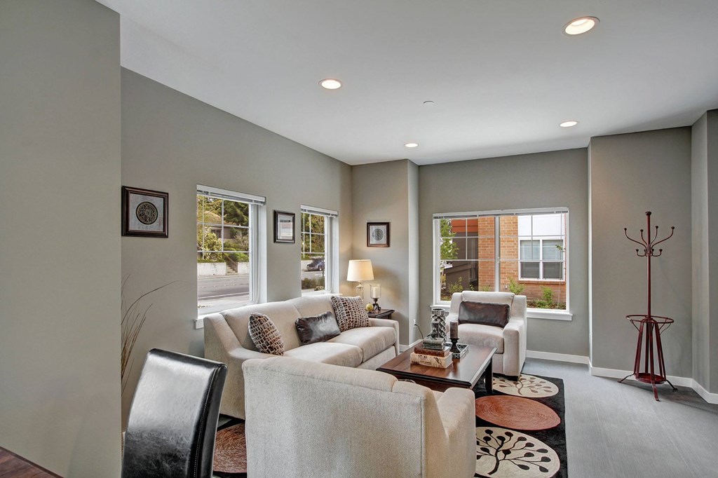 A living room with a couch, chairs, and a coffee table.