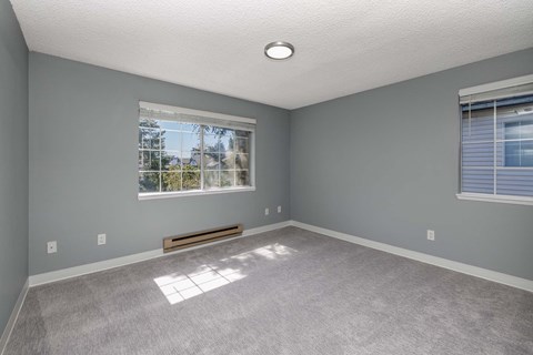 A room with a window and a bench.