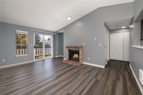 A living room with a fireplace and sliding glass doors.