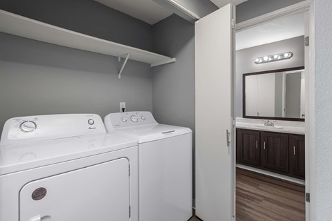 A white washing machine and dryer in a laundry room.