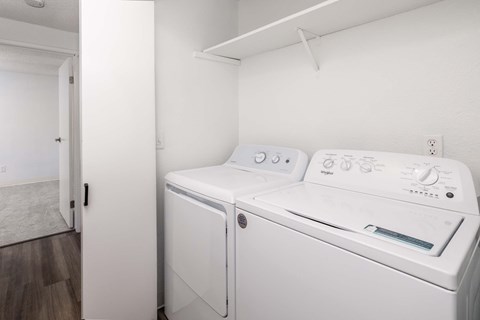 A white washing machine and dryer in a small room.