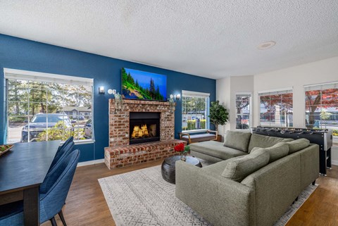 A living room with a fireplace and a painting on the wall.