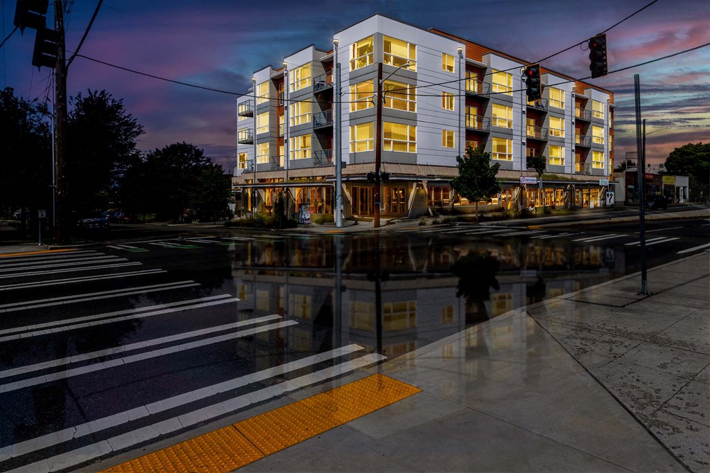 A modern building with a yellow line on the sidewalk in front of it.
