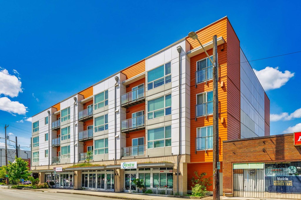 A modern multi-story building with a mix of orange and white colors.