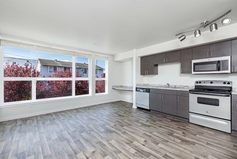 A kitchen with a stove top oven and microwave above it.