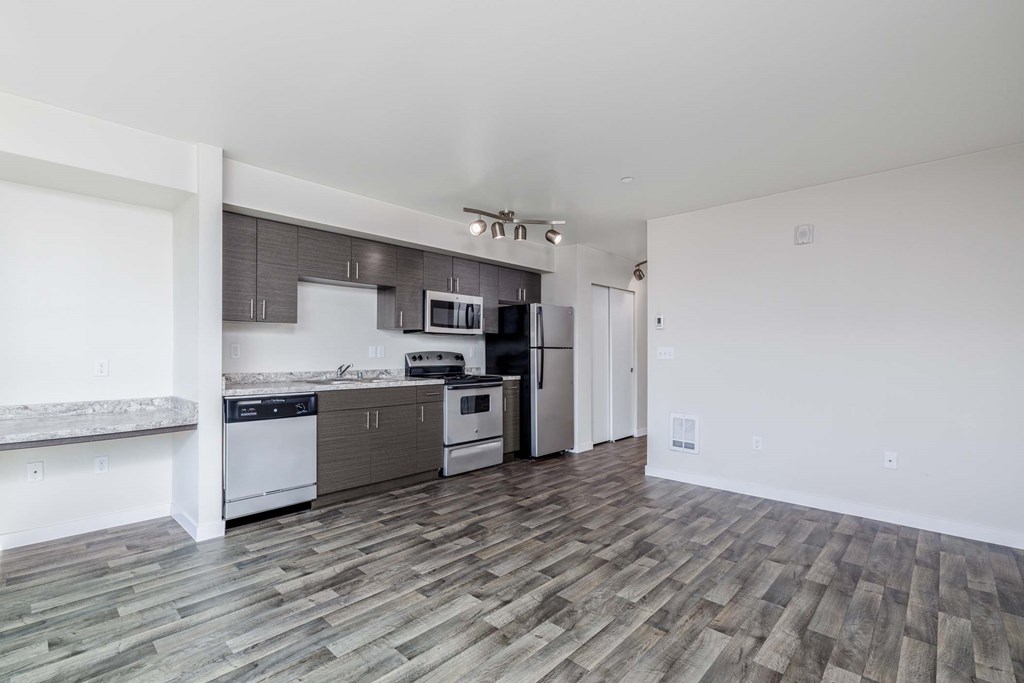 A kitchen with a white oven and microwave.