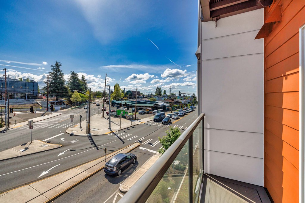 A car is driving on a road with a traffic light.