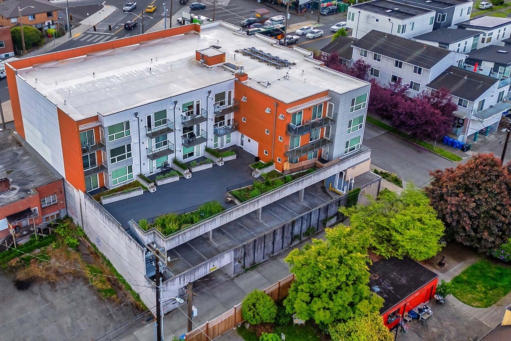A modern apartment building with orange and white exterior.