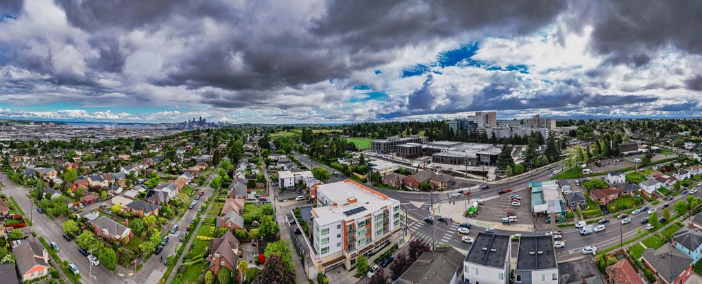 A cloudy day in a small town with a mix of residential and commercial buildings.