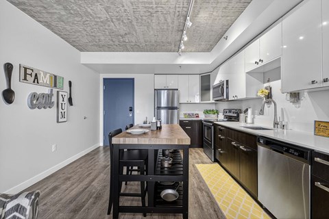 A kitchen with a dining table and chairs.