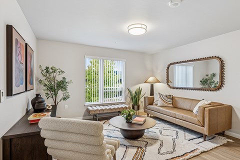 A well-lit living room with a couch, chair, and a coffee table.