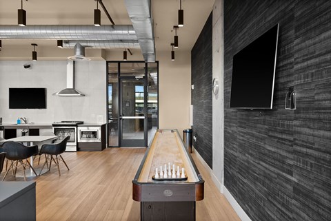 A room with a pool table and a bar area.