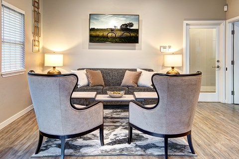 A living room with two chairs and a couch.