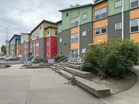 A colorful apartment complex with a bicycle parked in front.