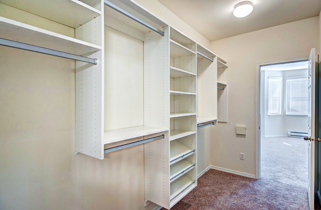 A room with a carpeted floor and a white door.