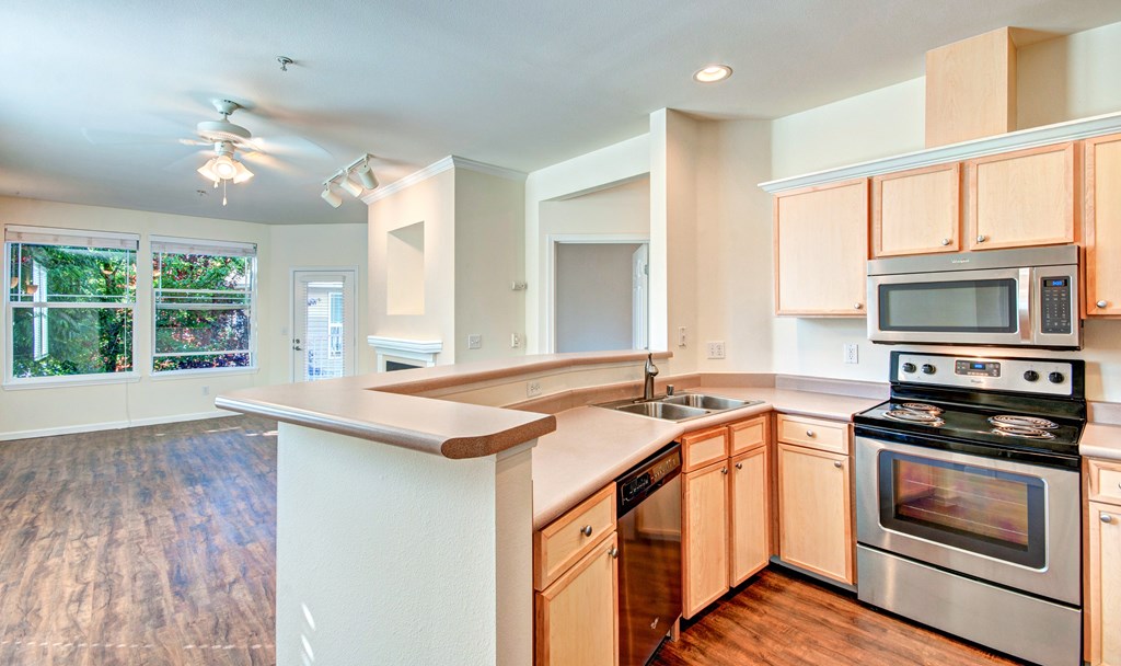 A kitchen with wooden cabinets and stainless steel appliances.