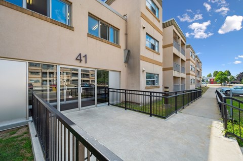 Apartment building number 41 with a black railing and a concrete walkway.