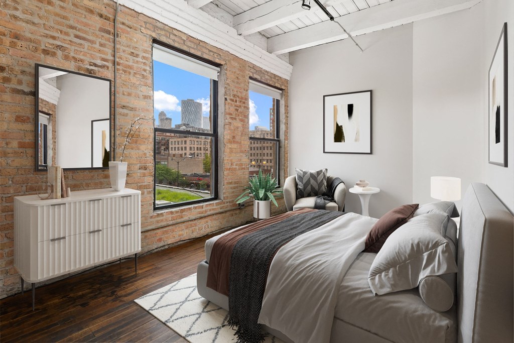 a bedroom with a bed and a large window