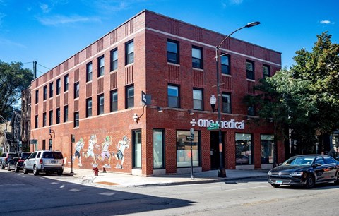 a red brick building on the corner of a city street